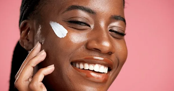face-cream-happy-black-woman-600nw-2652487343 Bảo vệ da bằng kem chống nắng là bước không thể thiếu sau liệu trình IPL